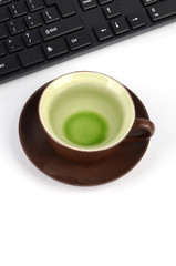 Fototapeta na wymiar Computer keyboard and cup of tea
