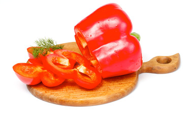 Bright red pepper with dill on the wood desk isolated on white.