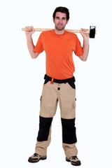 Fototapeta na wymiar full-length portrait of carpenter holding hammer at his back