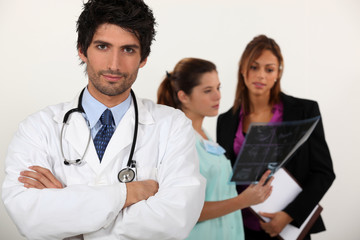 Doctor with medical staff in the background