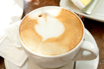 A cup of cappuccino with a beautiful crema, shooting