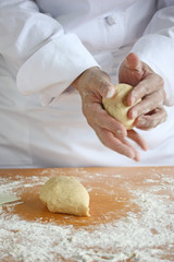 baker making bread , man hands , kneading a dough , cooking coat
