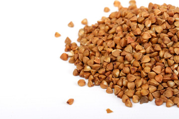 Isolated buckwheat on white background. Handful of grain