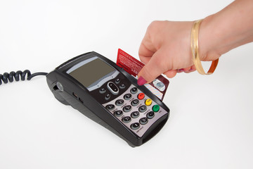 Close-up of hand holding plastic card in payment machine