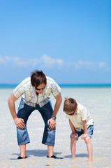 Father and son at shallow water