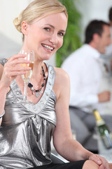 Woman drinking champagne in silver top