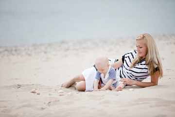 Fototapeta na wymiar happy mother and baby playing on beach