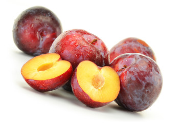 Composition with plums on white background