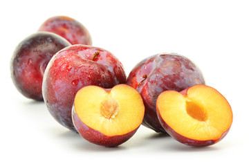 Composition with plums on white background