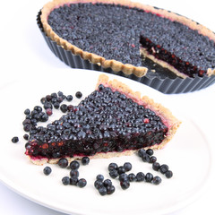 Blueberry Tart: a portion on a plate and in a tart pan