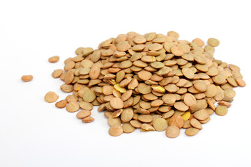 Pile of green lentils from low perspective isolated on white.