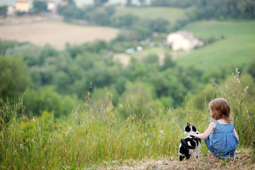 Adorable little girl and a cat outdoors