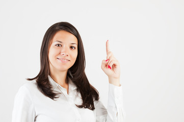 Happy smiling young business woman showing blank area for sign o