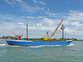 Fototapeta na wymiar ship carrying a bulldozer to the shipyards in Venice