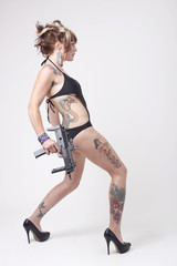 Sexy woman wearing swimsuit with an assault gun