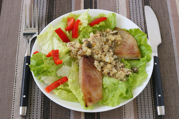 Fried fish with sauce and salad