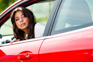 Young pretty woman looking at back of car