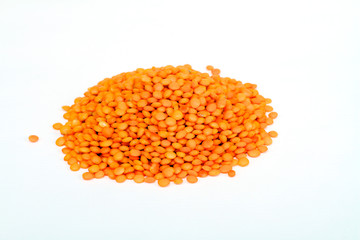Heap of raw red lentils isolated on white background