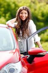 Young pretty woman in the red car