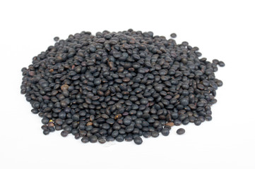 Heap of black lentil isolated on white