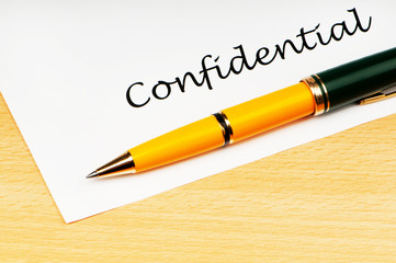 Pen and confidential message on white