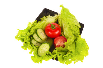 green salad, tomatoes and cucumber isolated on the white background