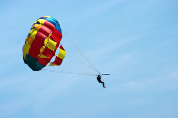 Silhouette of man with parachute on the sky