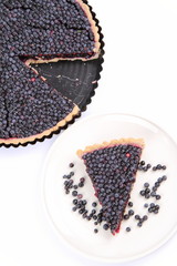 Blueberry Tart: a portion on a plate and in a tart pan