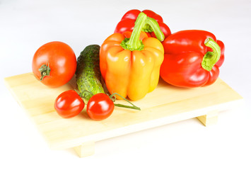 fresh and juicy vegetables on the wood plate isolated