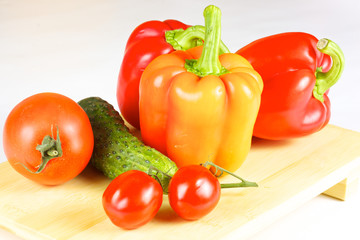 fresh and juicy vegetables on the wood plate isolated