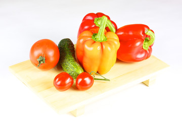 fresh and juicy vegetables on the wood plate isolated