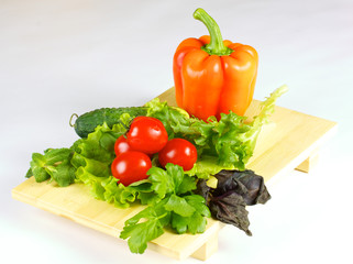 fresh and juicy vegetables on the wood plate isolated
