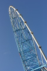 Ferris wheel against a blue sky in the amusement park
