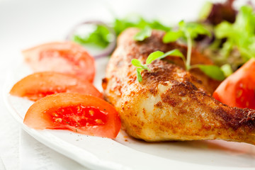 Roasted chicken leg with vegetables and thyme