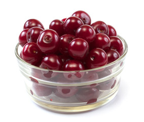 Bowl with ripe cherries. Isolated on a white background.