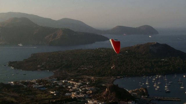 Paragliding over the archipelago at dusk