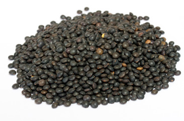 Heap of black lentil isolated on white