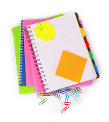 bright notebooks and paper clip isolated on white