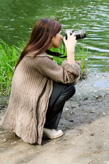 The young girl with the camera in park