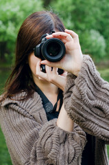 The young girl with the camera in park