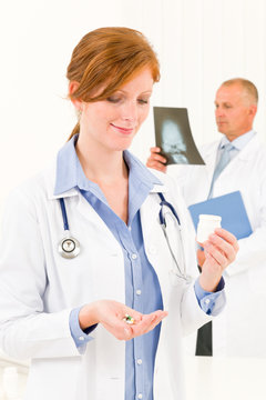 Medical doctor team young woman hold pills
