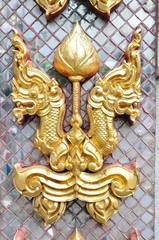 Golden naga head on decorated mirror pattern