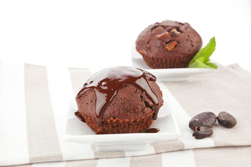 Chocolate muffins on kitchen cloth.