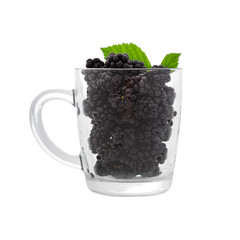 Blackberries in clear cup with green leaves