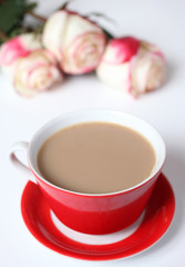 Cup of coffee and flowers on a white background