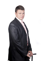 Portrait of a smiling young businessman standing agains