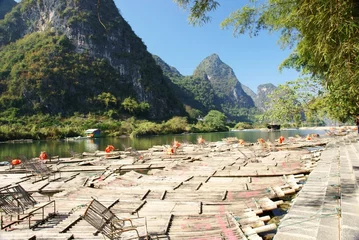 Fotobehang Bamboo raft with hill and river © cityanimal