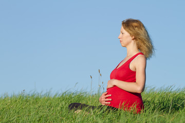 pregnant woman on meadow