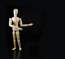 humanoid doll says something with a black background