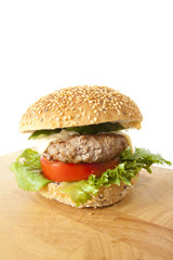 jink food, beef and cheese hamburger on wood plate.